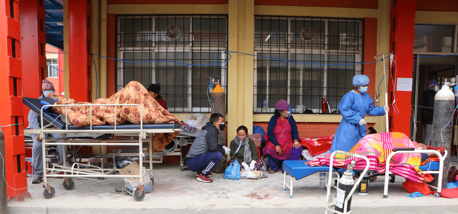 COVID-19 patients are being treated in an open space of an hospital entrance at a local hospital in Nepal
