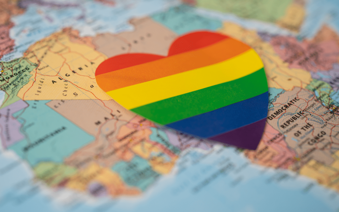 Rainbow colour heart on world map showing Africa.