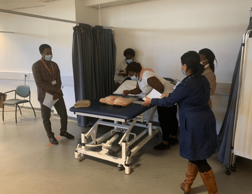 The Fellows attending to a dummy model in a clinic in Salford