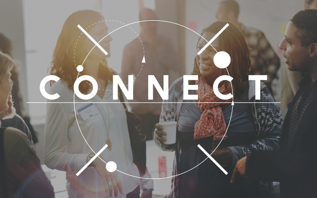 Diverse group of people talking at an event with overlaid text 'Connect'.