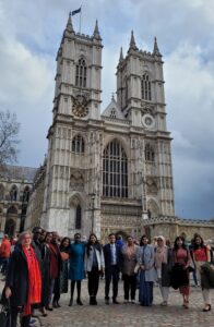 Commonwealth Scholars and Commissioners standing in front of Westminster Abbey.