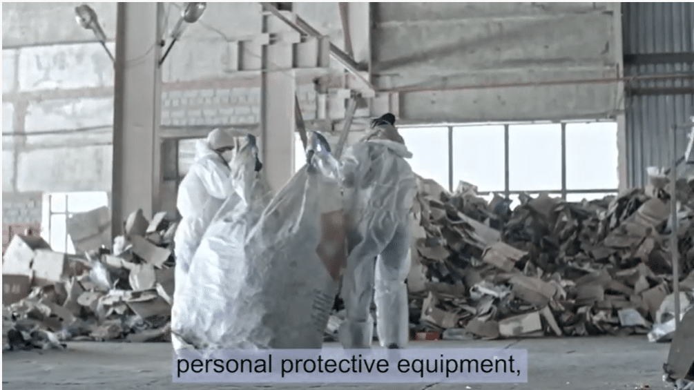 People in protective clothing cleaning warehouse