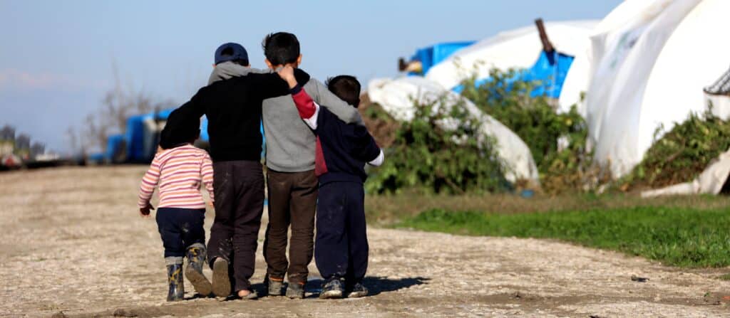 Photo of refugee Syrian children hugging in the camp