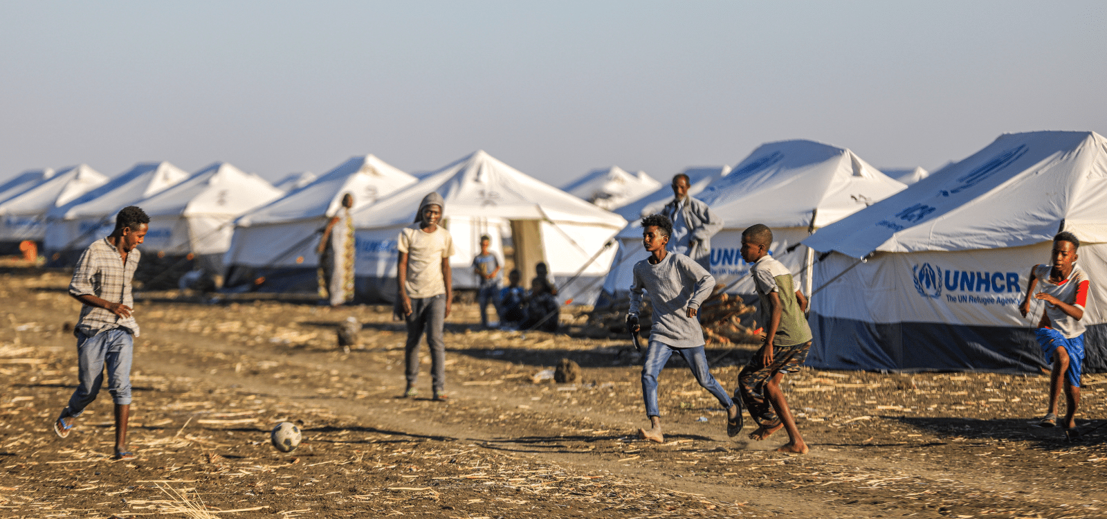 Young people playing football in refugee camp in Ethiopia