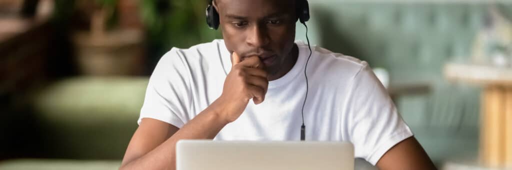 Photo of focused man on laptop
