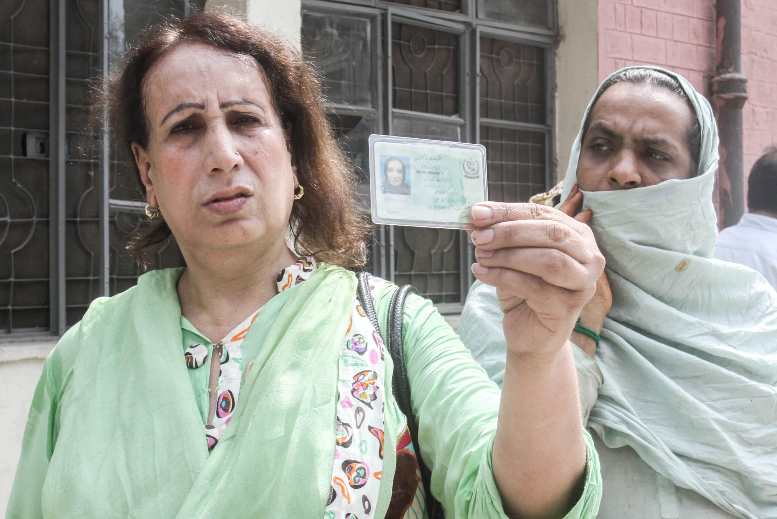 Pakistani Transgender person holds her national identity card outside a polling station in Lahore