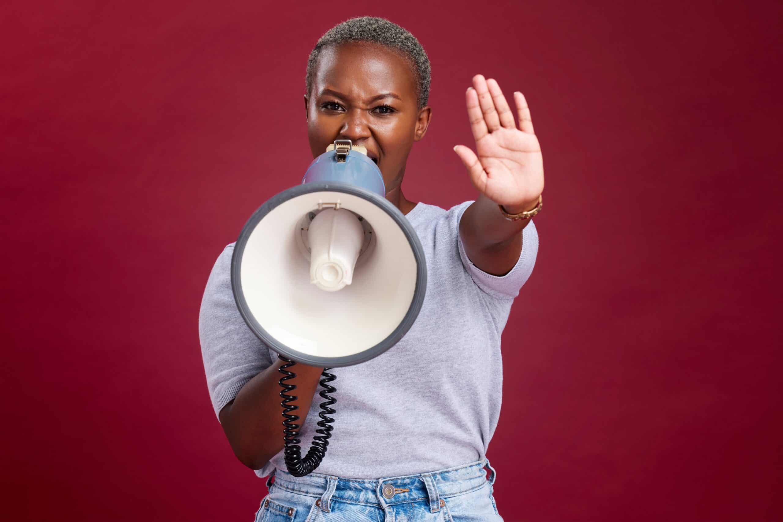 Woman protesting and shouting with a megaphone