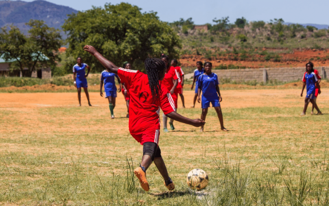 Girl in Africa playing football