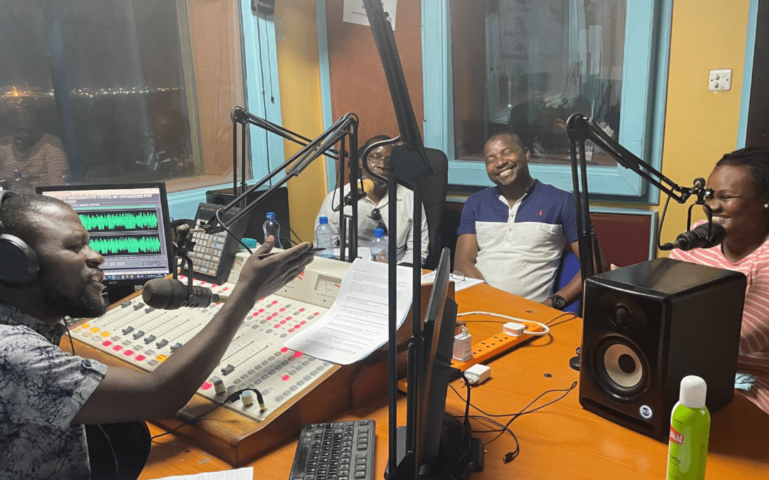 Radio presenter raising questions to speakers in radio studio