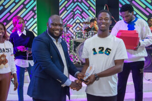 A young man receiving their Youth Award prize