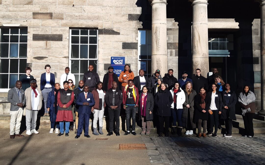Large group of Fellows and staff standing in front of university building at Fellows Welcome Event 2023.