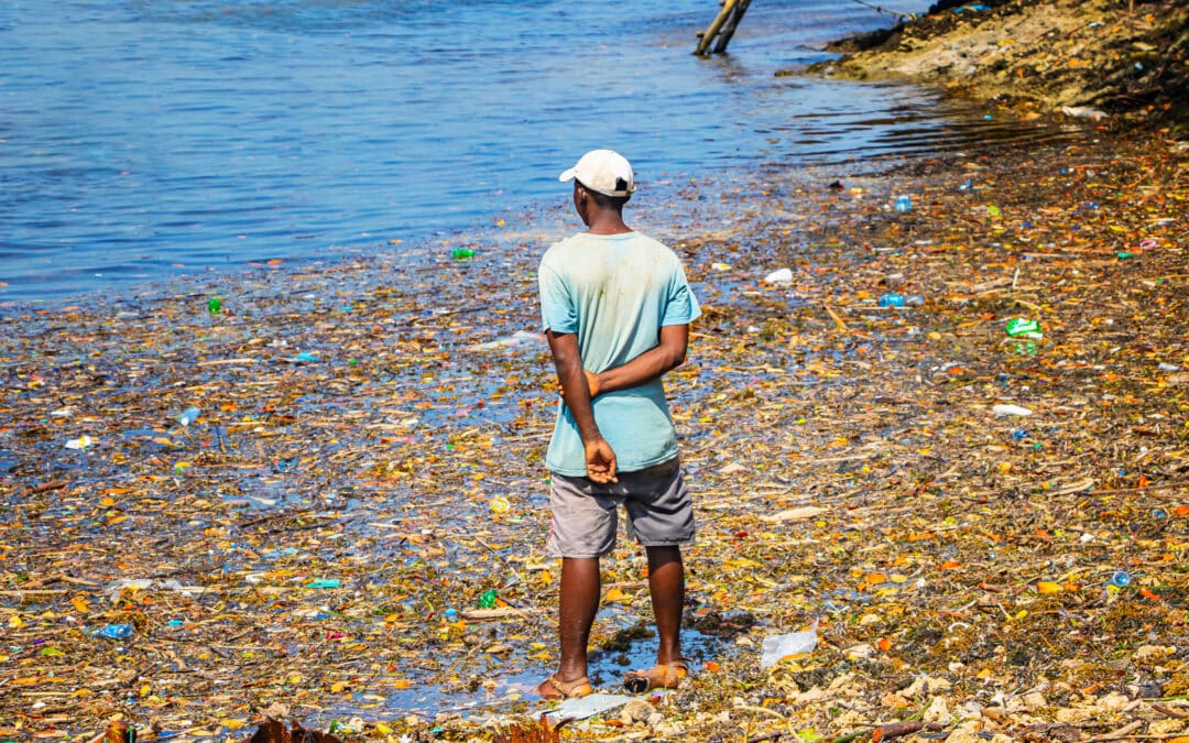 A man stands in the garbage washed up on the coastline of Wasini island, Kenya.