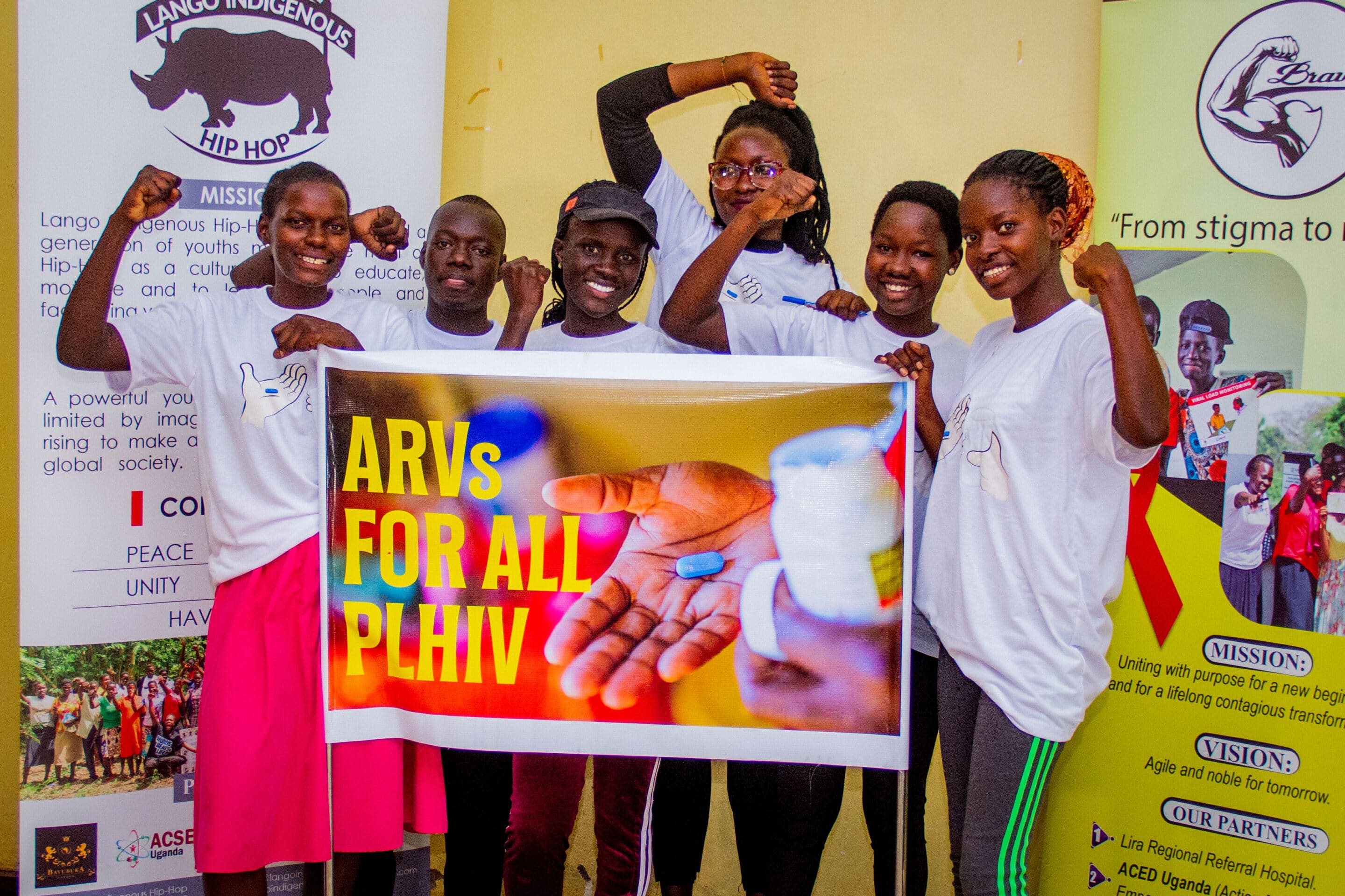A group of young people holding a banner advocating for ARV's for all PLHIV