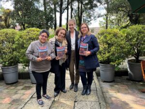 Dr Julia Zulver with 3 women with Julia's book from the book launch in Bogota