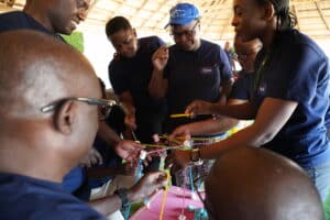 Group of alumni work together to build a tower