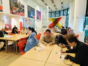 Alumni sit at tables in small groups