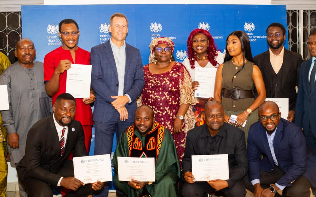 Group of recently returned Commonwealth and Chevening Scholars stand with the British High Commissioner