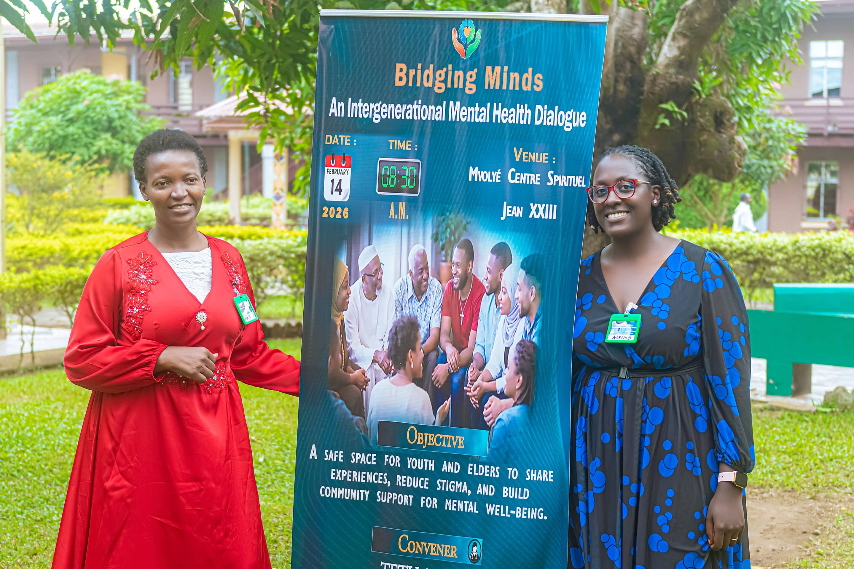 Two women standing against a banner